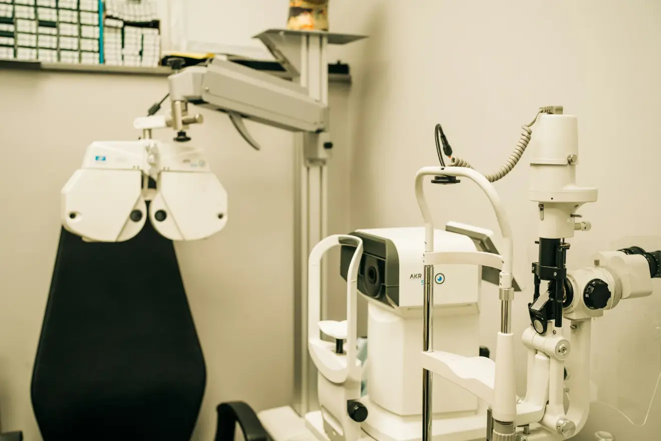 Eye-examination instruments beside an empty chair in a consulting room.