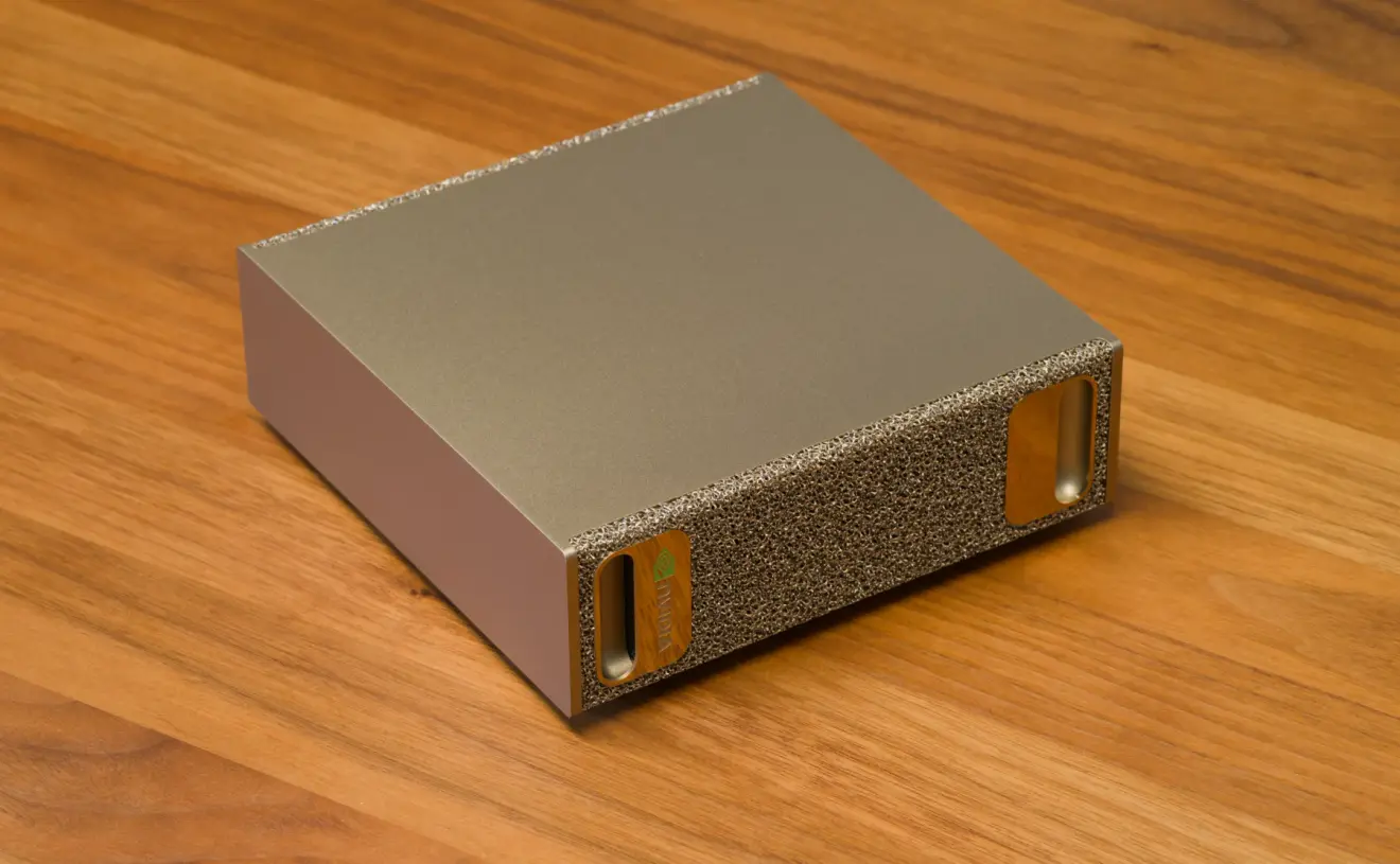 An NVIDIA DGX Spark desktop AI computer photographed on a wooden surface.