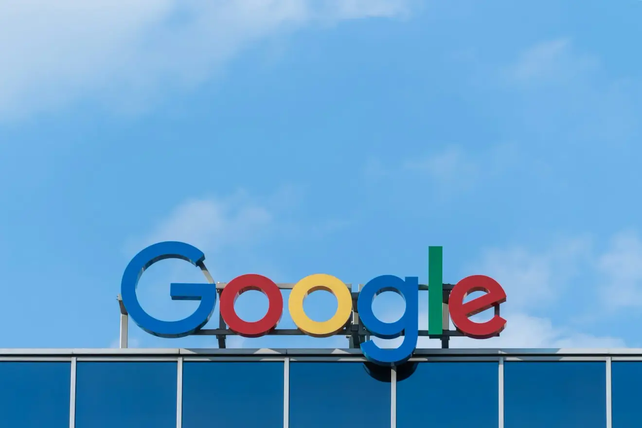 Google signage above a glass building against a blue sky in Wroclaw, Poland
