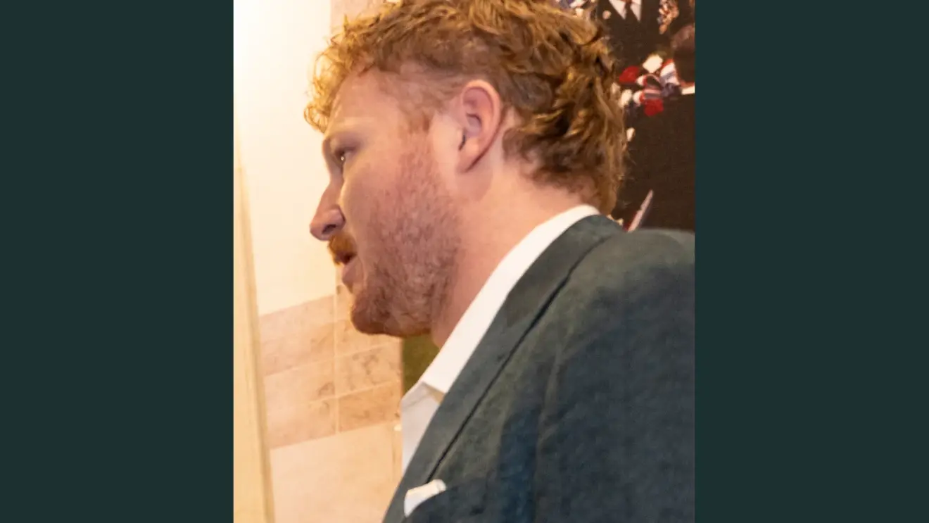 Cam Jurgens in a suit during the Eagles visit to Arlington National Cemetery in April 2025